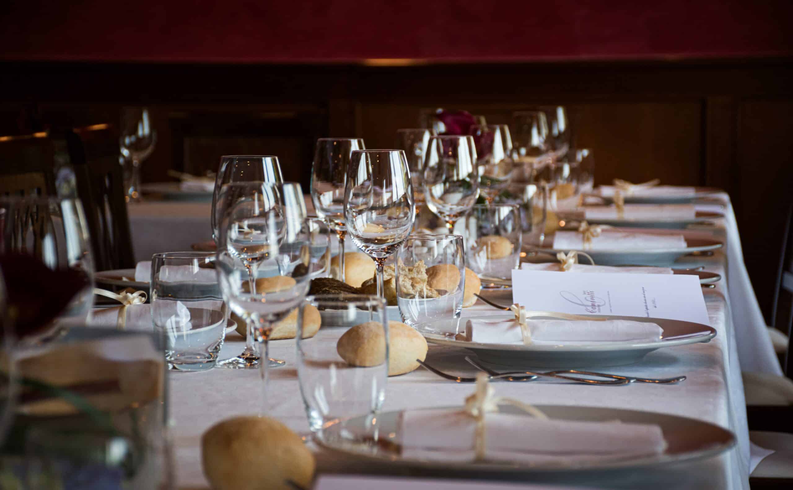 Wedding tables all set up with plates, glassware and other decor