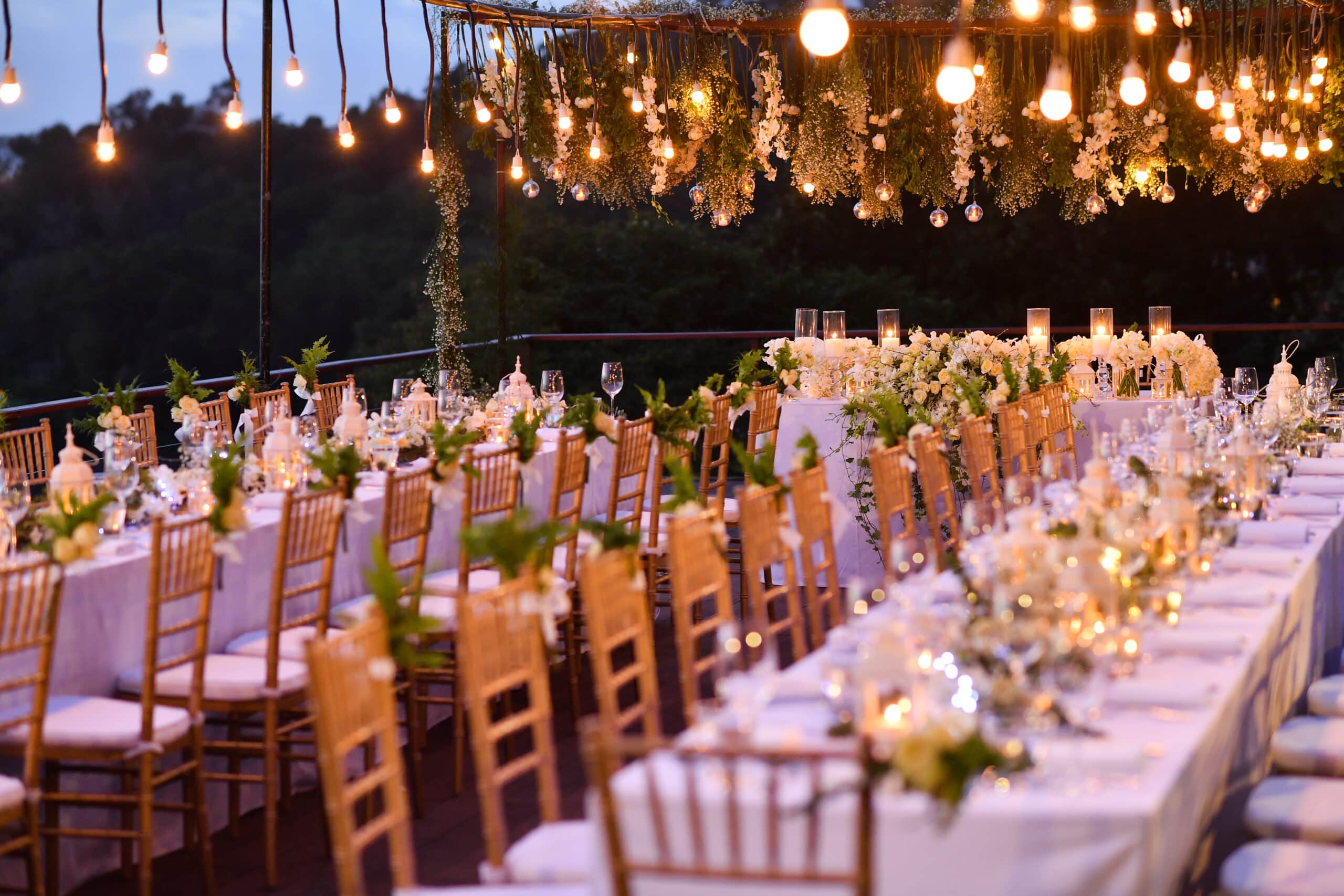 Wedding tables all set up with plates, glassware and other decor