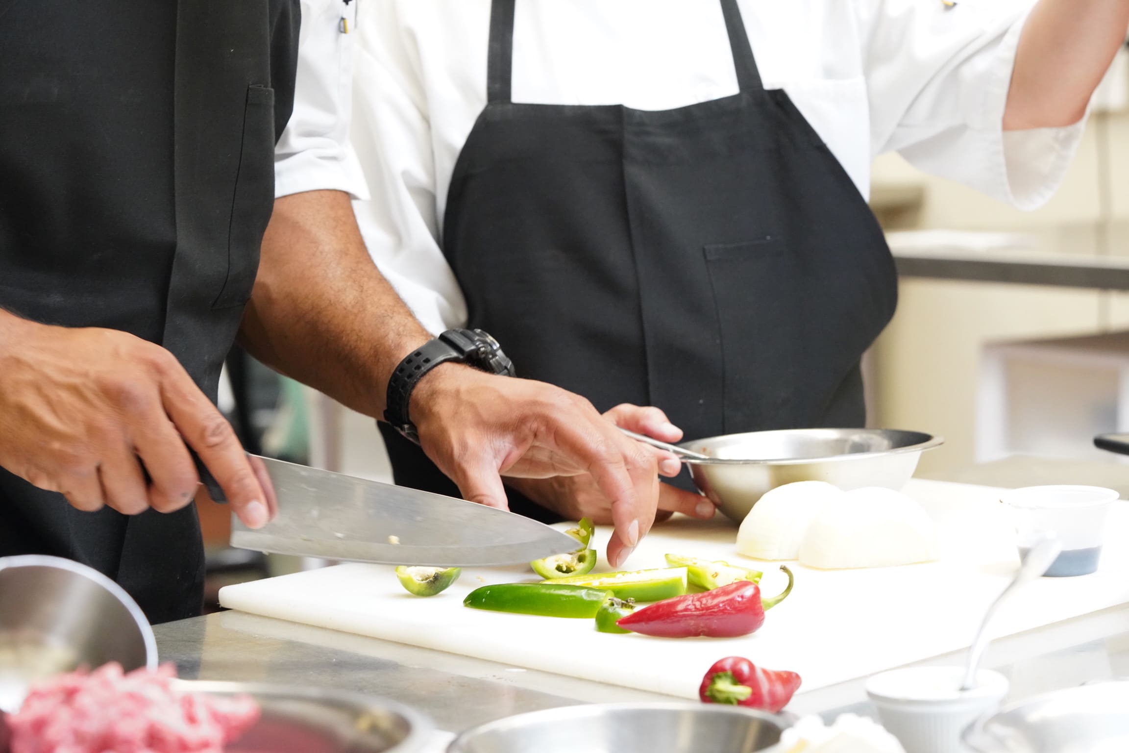 Chef cutting peppers