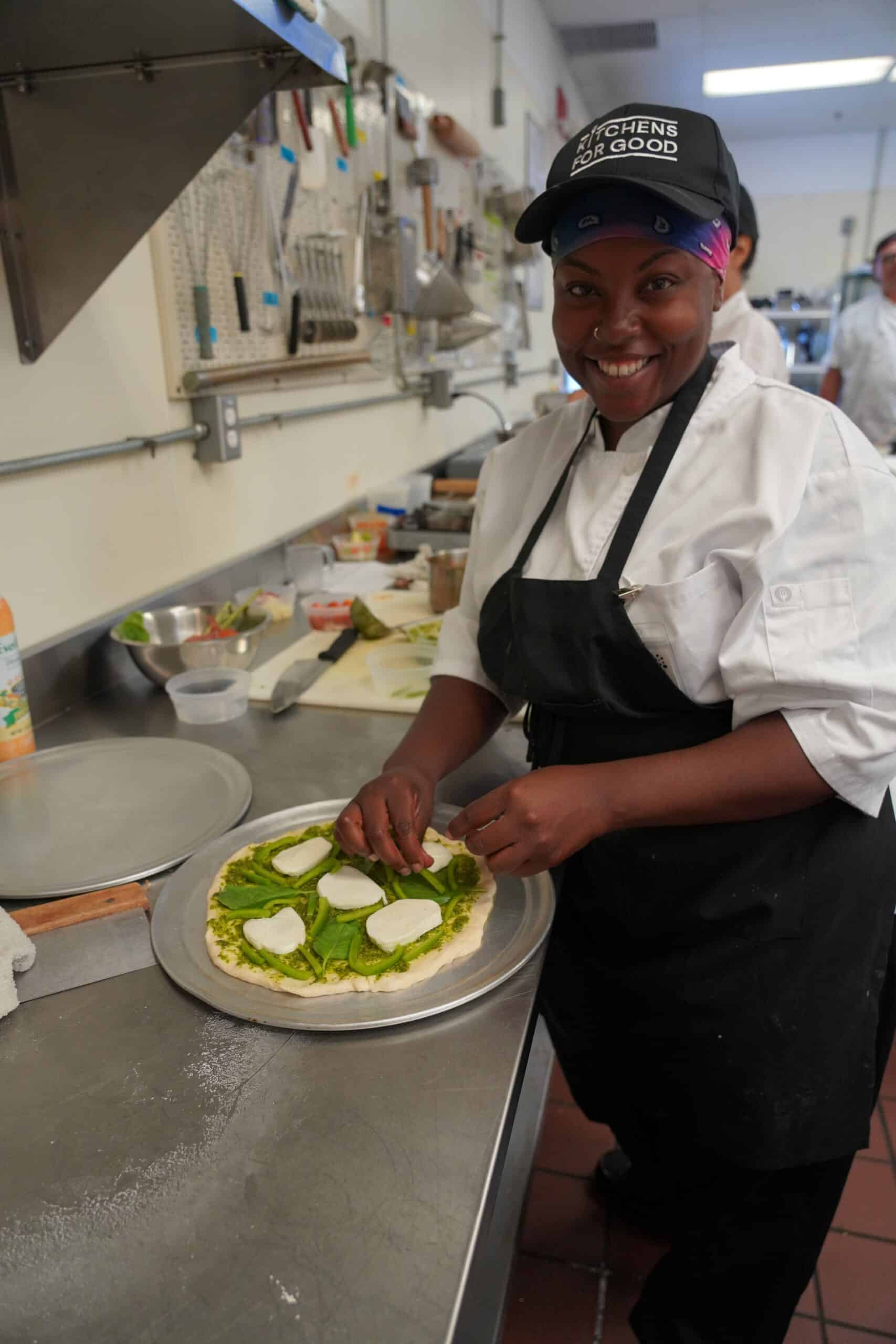 Latara prepares food during her Kitchens for Good culinary apprenticeship.