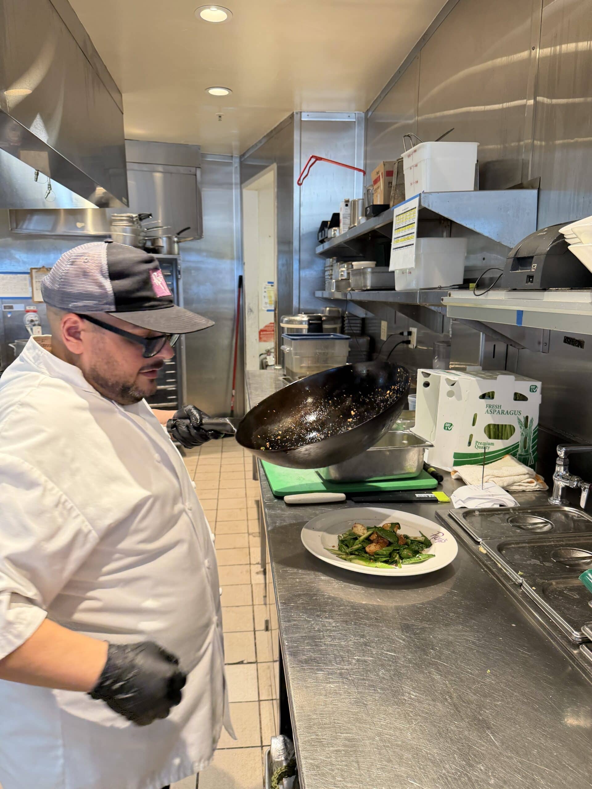 Kitchens for Good apprentice preparing a dish in the kitchen at Roy’s San Diego