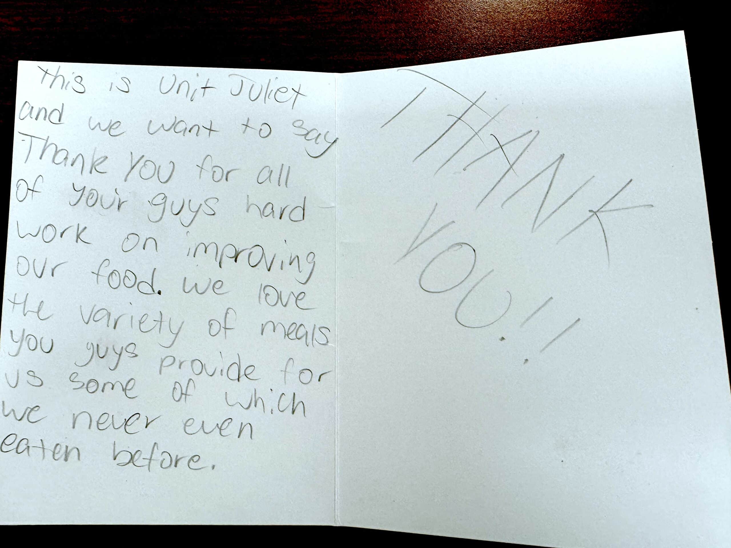Handwritten thank-you note from youth participants thanking Kitchens for Good for improving their food and providing meals